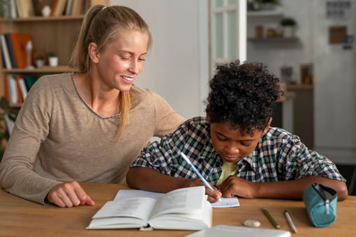 Front view woman helping kid with homework
